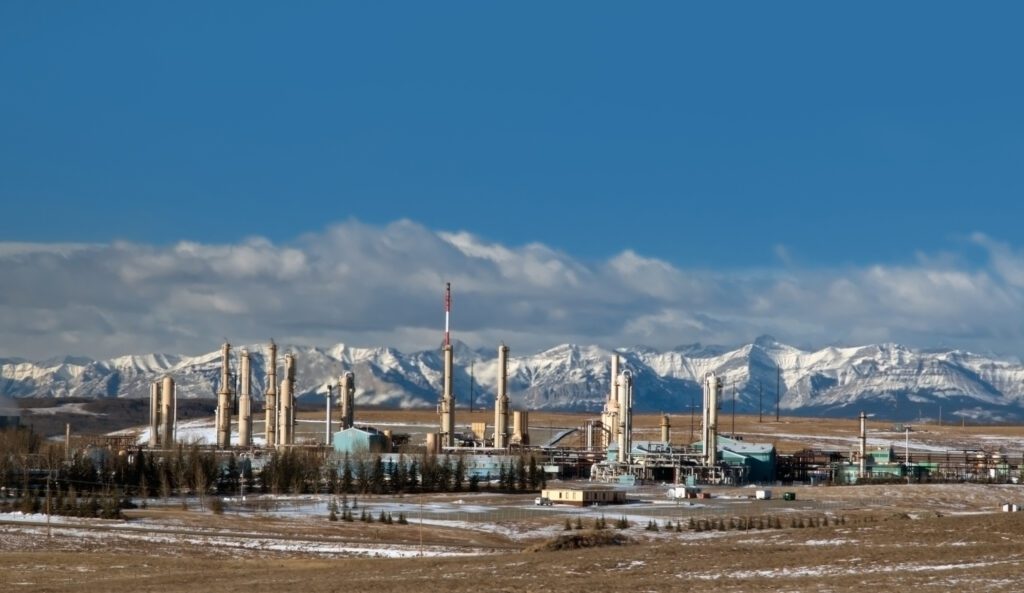 Gas plant near Cochrane, Alberta with the Rocky Mountains in the background