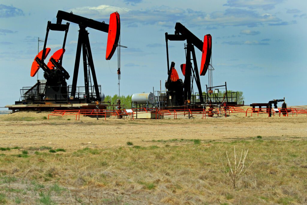 Pumps being oil or gas to the surface in Albera. The landscape includes many of these mechanical beasts on the praires.